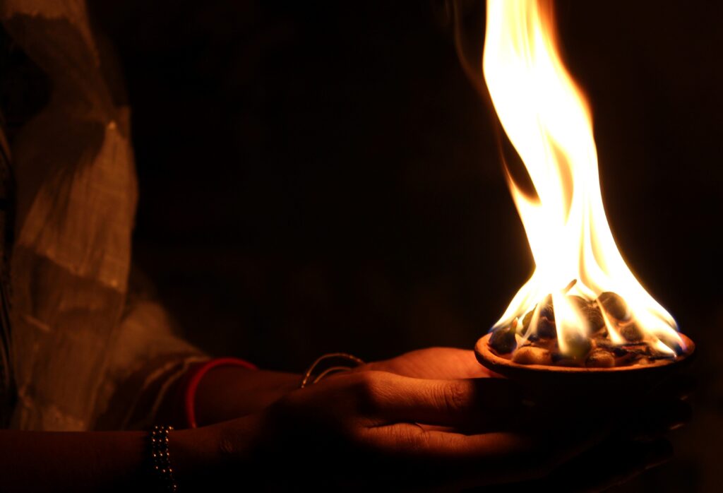 Canva - Hand Holding Flame for Indian Celebration